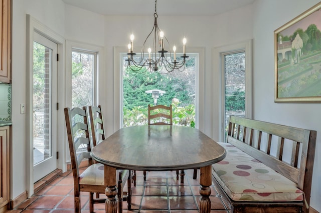 tiled dining room featuring a chandelier