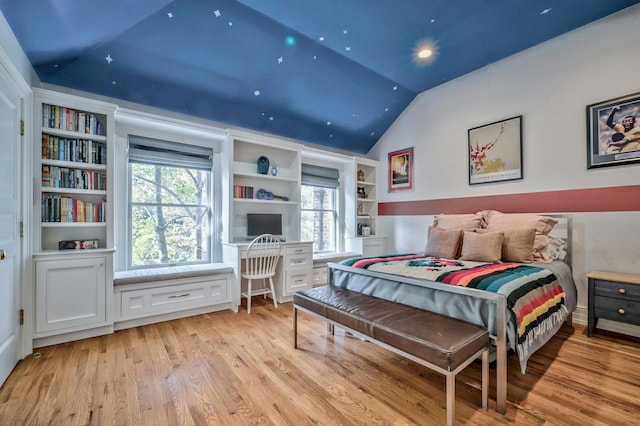 bedroom with vaulted ceiling and light hardwood / wood-style floors