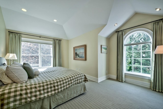 bedroom with multiple windows, lofted ceiling, and light carpet