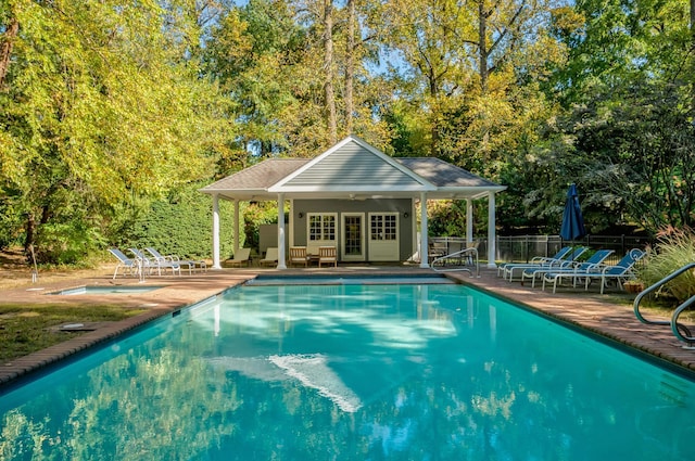 view of swimming pool featuring a patio and an outdoor structure