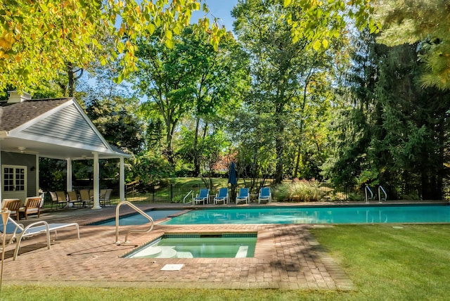 view of pool featuring an in ground hot tub and a patio