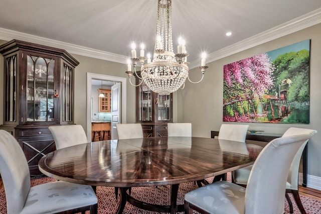 dining area featuring an inviting chandelier, hardwood / wood-style floors, and ornamental molding