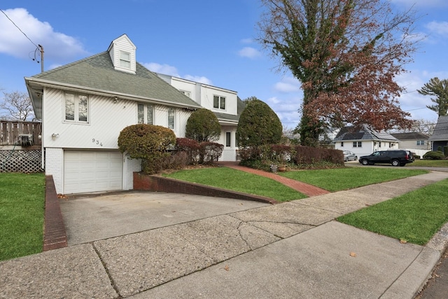 view of front of house with a front yard and a garage