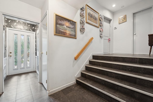 entryway featuring dark tile patterned floors