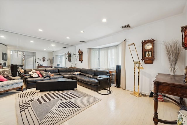 living room featuring ornamental molding and light wood-type flooring