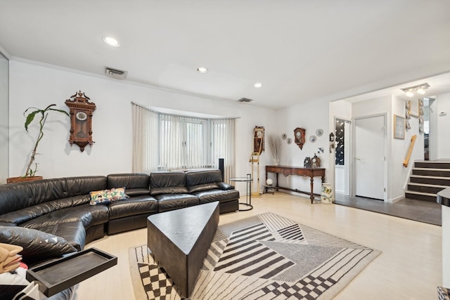 living room with crown molding and light hardwood / wood-style flooring