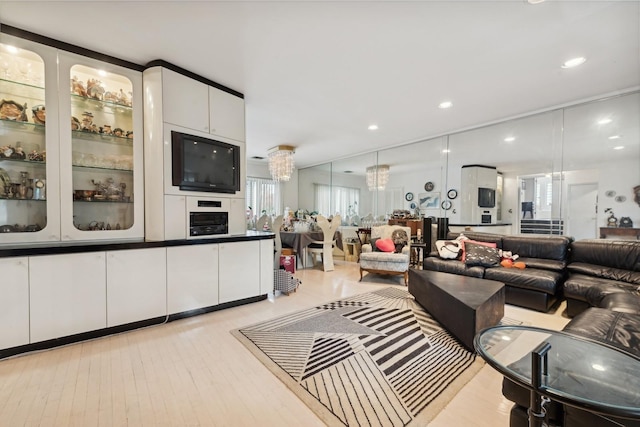 living room with light hardwood / wood-style floors and a chandelier