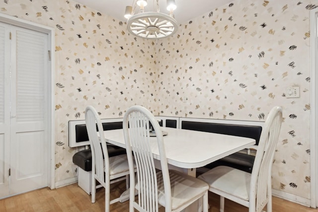 dining area featuring a notable chandelier and light wood-type flooring