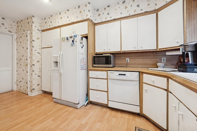 kitchen featuring white cabinetry, tasteful backsplash, white appliances, and light hardwood / wood-style flooring