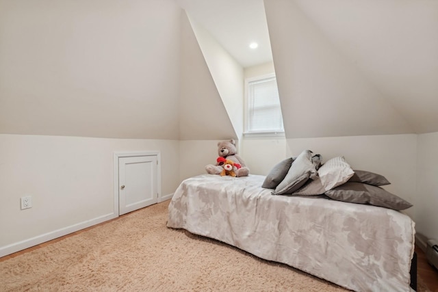 bedroom with a baseboard heating unit and lofted ceiling