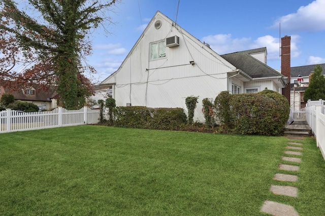 view of home's exterior with a wall unit AC and a yard