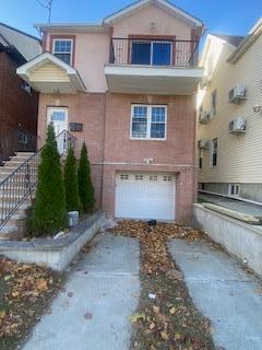 view of front of home featuring a balcony and a garage