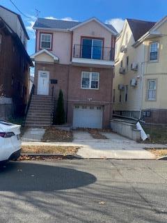 view of front of home with a balcony and a garage