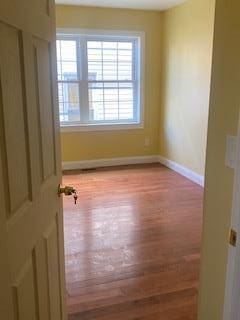 spare room with light hardwood / wood-style floors