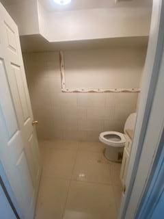 bathroom featuring tile patterned flooring and toilet