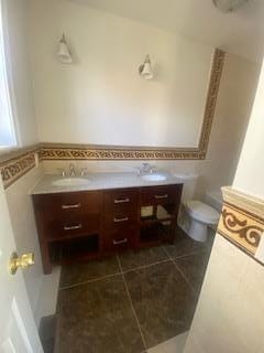 bathroom featuring tile patterned floors, vanity, and toilet