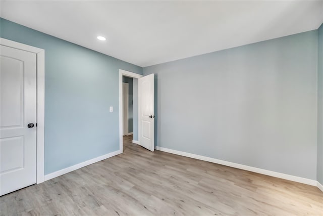 unfurnished room with light wood-type flooring