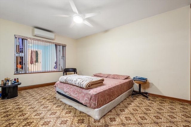 bedroom featuring a wall unit AC and ceiling fan