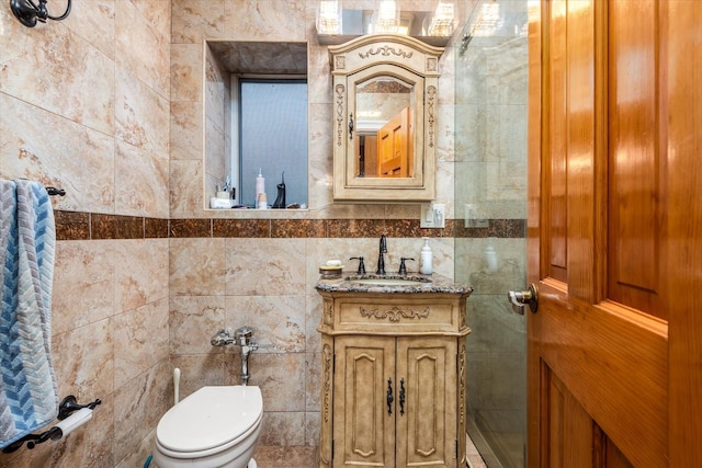 bathroom with vanity, toilet, and tile walls