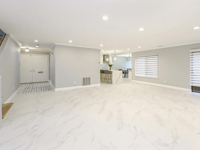 basement featuring plenty of natural light and ornamental molding