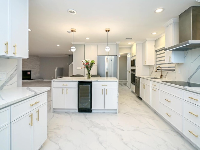 kitchen featuring pendant lighting, white cabinetry, wall chimney range hood, and appliances with stainless steel finishes