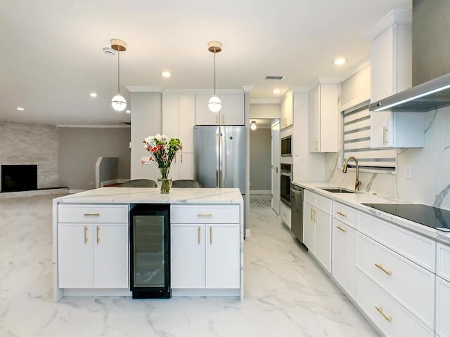 kitchen featuring pendant lighting, wall chimney exhaust hood, white cabinets, and beverage cooler