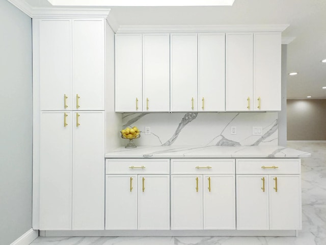 bar featuring white cabinetry, decorative backsplash, and light stone counters