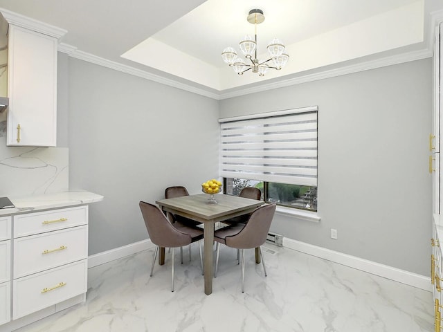 dining room featuring ornamental molding, a tray ceiling, and a chandelier