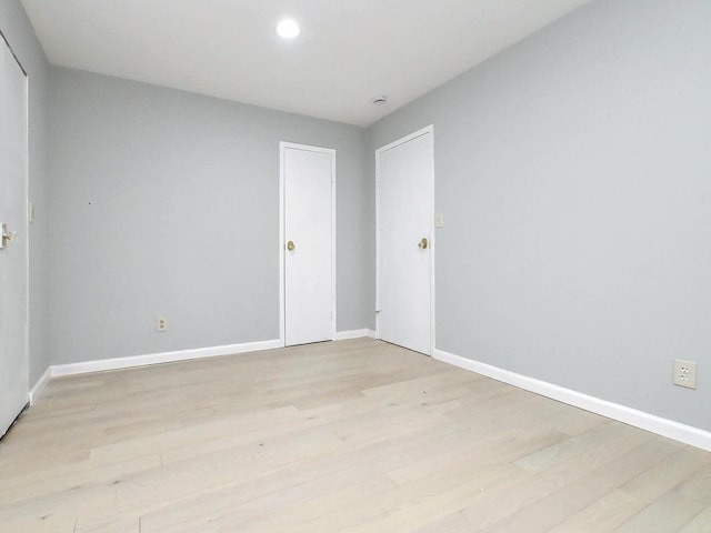 unfurnished room with light hardwood / wood-style floors