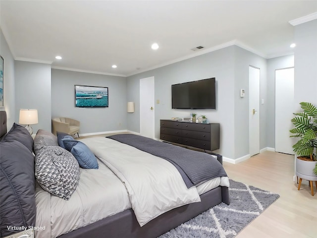 bedroom with light wood-type flooring and ornamental molding