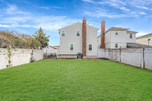 rear view of house featuring a yard