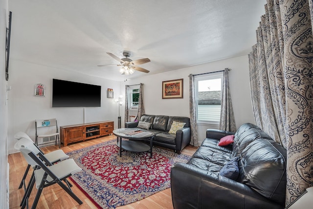 living room featuring hardwood / wood-style flooring and ceiling fan