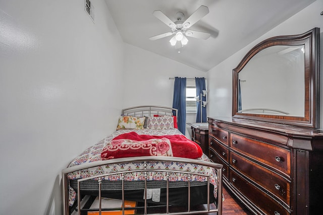 bedroom featuring hardwood / wood-style floors, ceiling fan, and vaulted ceiling