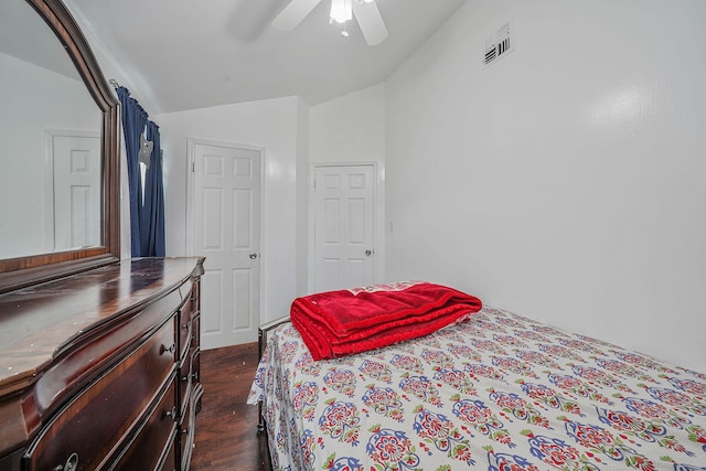 bedroom with vaulted ceiling, ceiling fan, and dark wood-type flooring