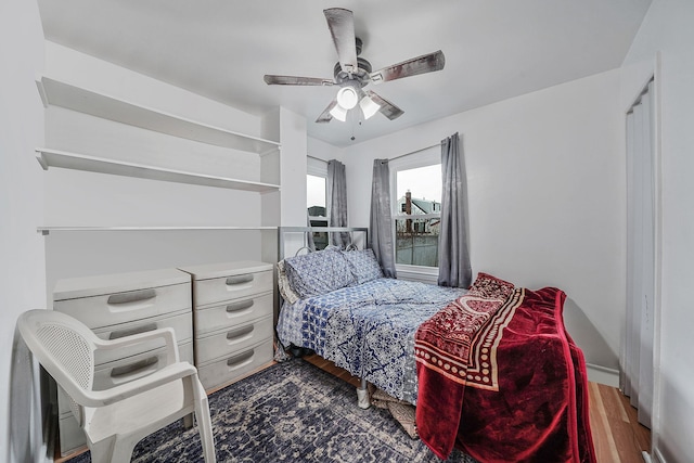 bedroom featuring ceiling fan and dark hardwood / wood-style floors