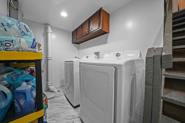 laundry area featuring cabinets and washing machine and clothes dryer