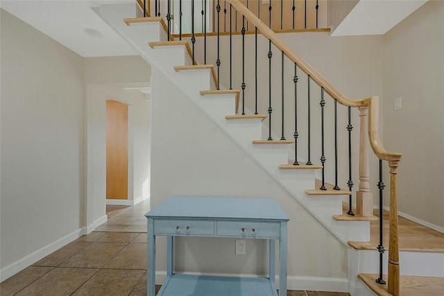 stairs with tile patterned floors