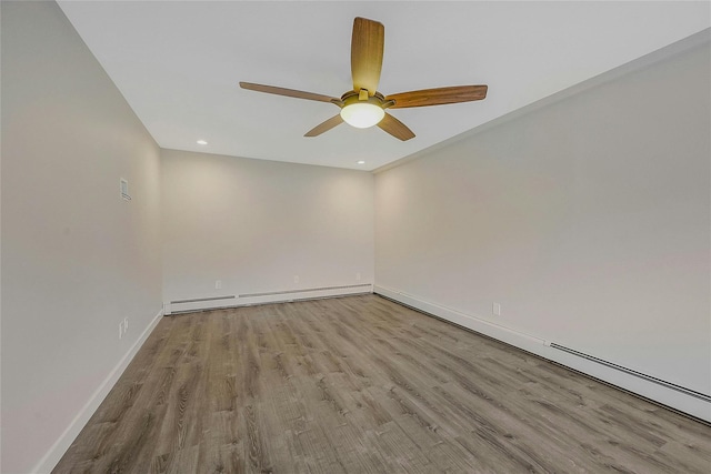 unfurnished room featuring ceiling fan, baseboard heating, and light hardwood / wood-style flooring