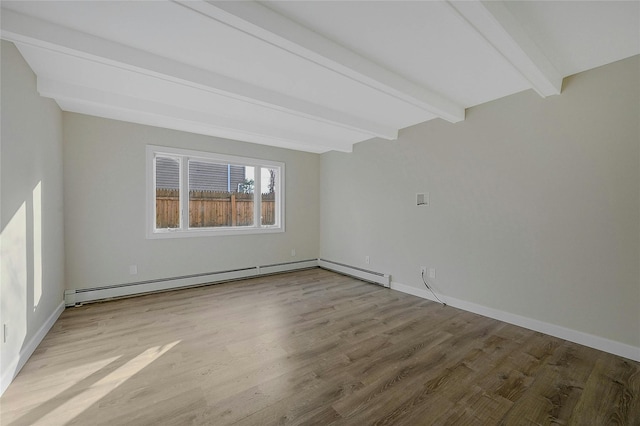 empty room featuring beamed ceiling, a baseboard heating unit, and light hardwood / wood-style flooring