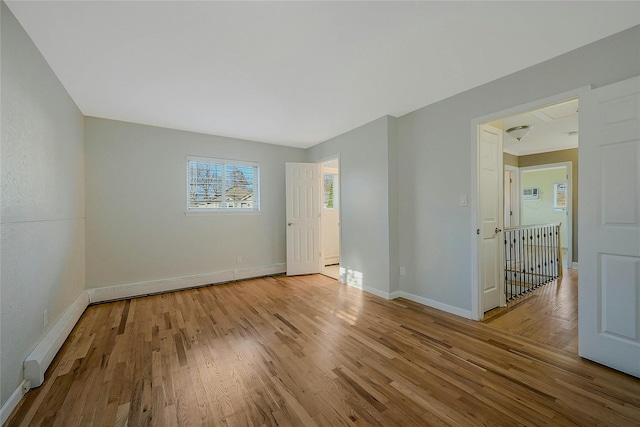 unfurnished room featuring light hardwood / wood-style floors and a baseboard radiator