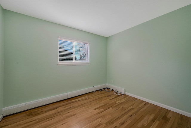 spare room featuring light hardwood / wood-style flooring and baseboard heating