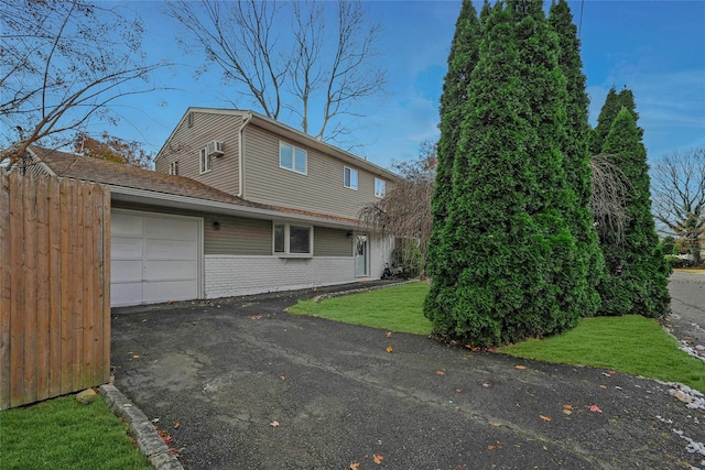 view of side of property with a garage and a yard