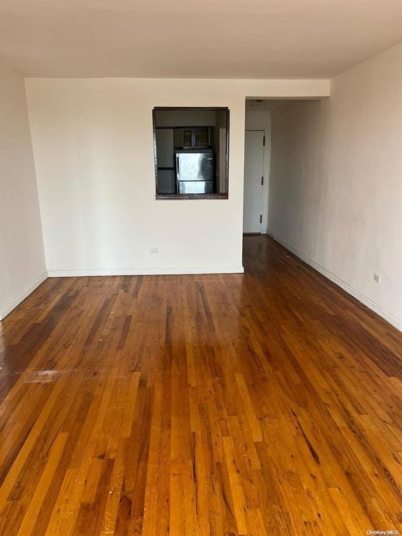 empty room with dark hardwood / wood-style floors