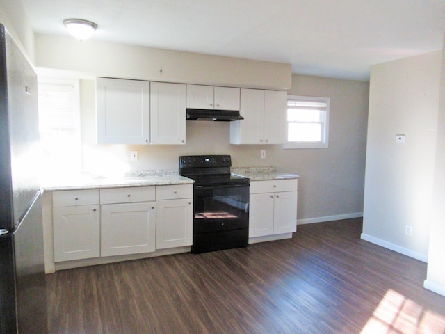 kitchen with stainless steel fridge, dark hardwood / wood-style flooring, white cabinetry, and black / electric stove