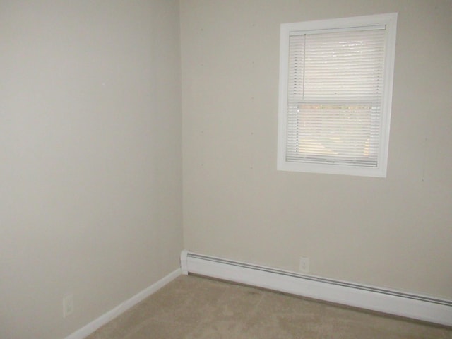 carpeted spare room featuring baseboard heating