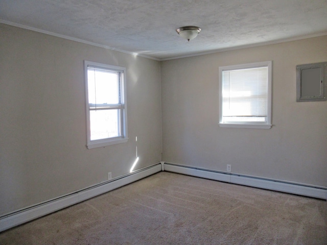 carpeted empty room featuring a textured ceiling, baseboard heating, and crown molding