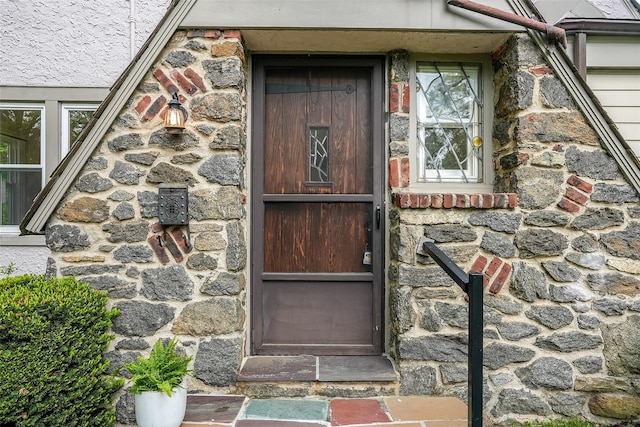 property entrance with stone siding