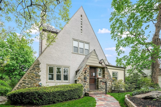 view of front of home featuring stone siding and stucco siding