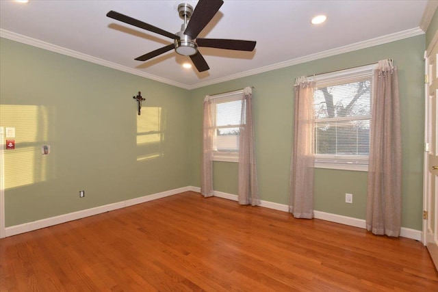 spare room featuring ceiling fan, ornamental molding, and light wood-type flooring