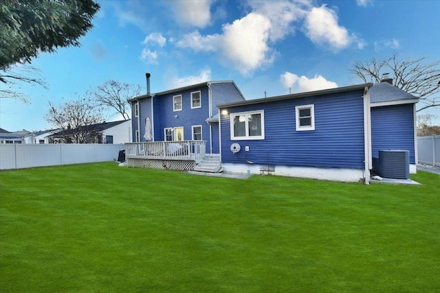 back of house featuring a deck, a yard, and central air condition unit